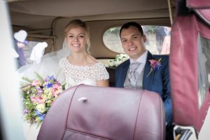 Amy and Josh leaving their wedding in their wedding car