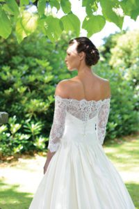 Designer sleeved, off-the-shoulder wedding dress by Ivory and Co at Boho Bride boutique in Stratford Upon Avon, Warwickshire