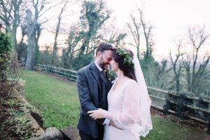 Bride wearing sleeved wedding dress from Boho Bride