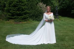 Bespoke wedding dress with sleeves and a long train. Made by Lola and Em bridal designers in association with Boho Bride Boutique in Stratford Upon Avon