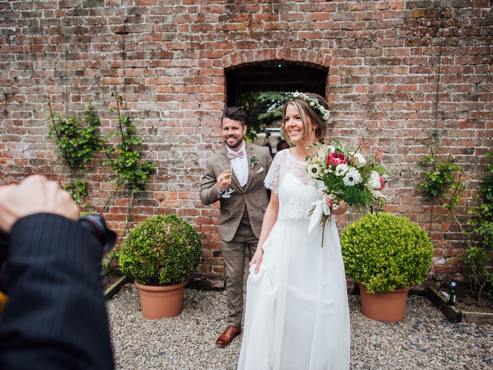 bride and groom entering walled garden wedding venue georgian house