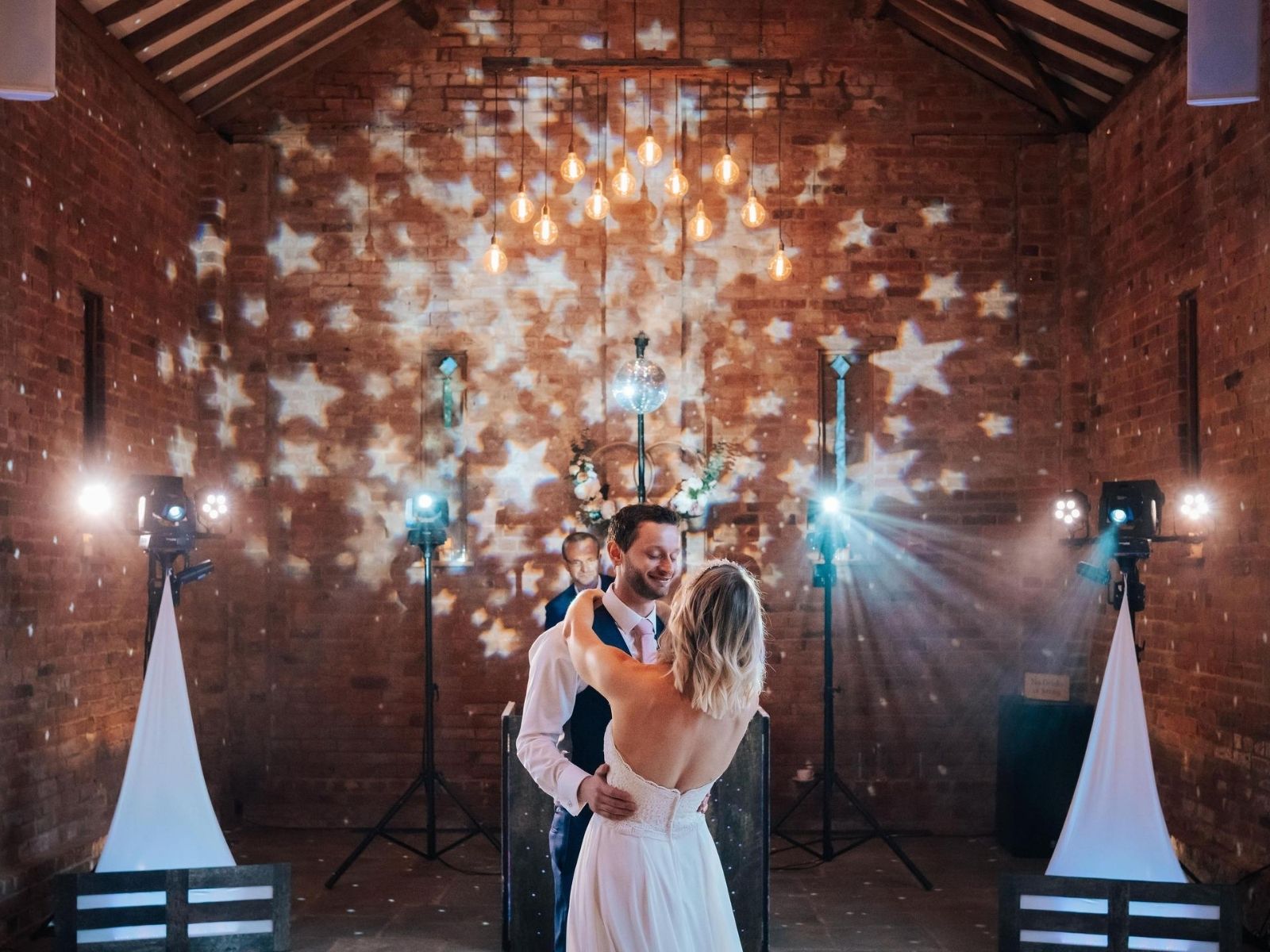 Couple sharing their first dance at relaxed barn wedding 