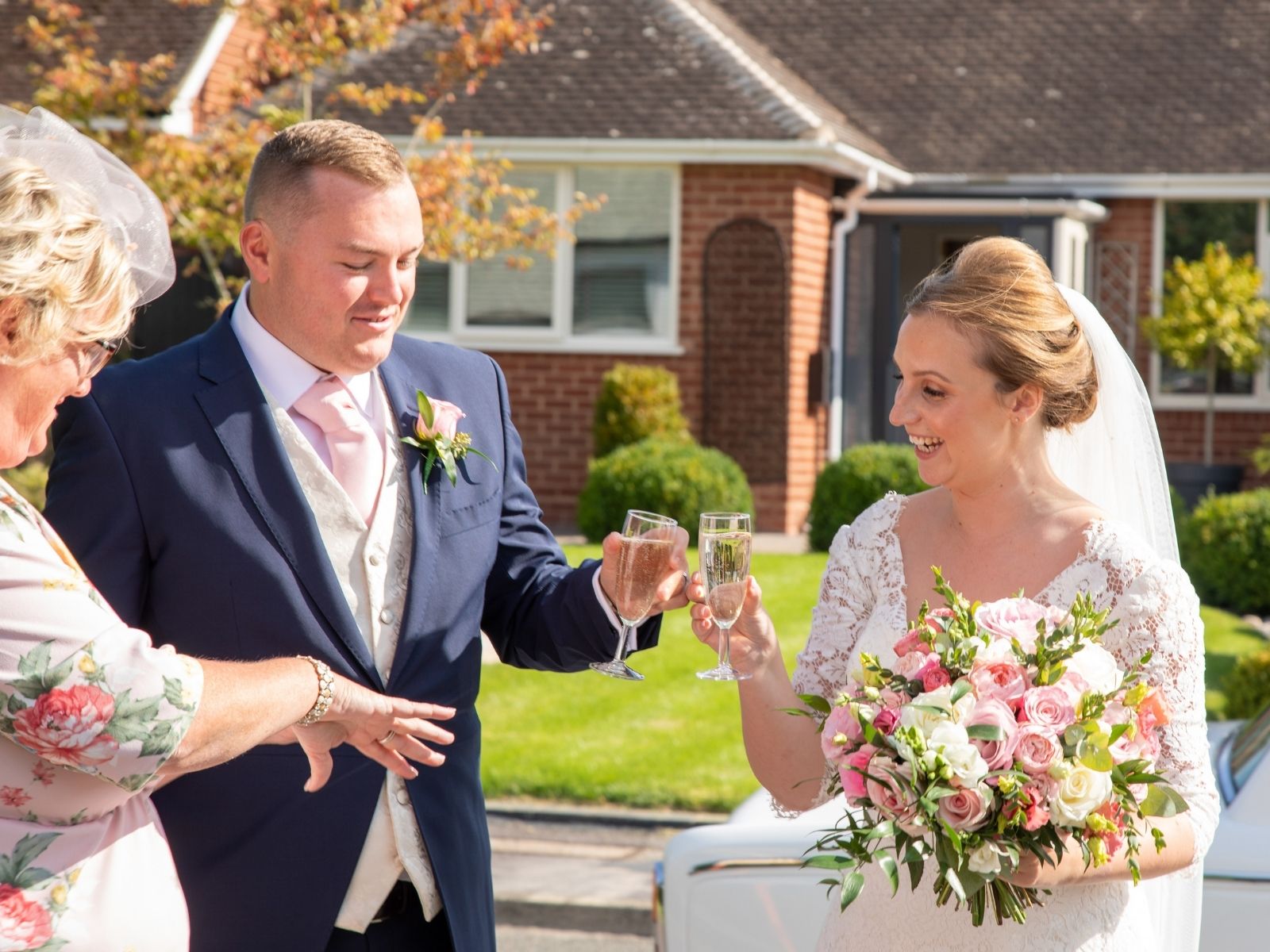 Rachel and Shaun clinking champagne glasses after their wedding ceremony