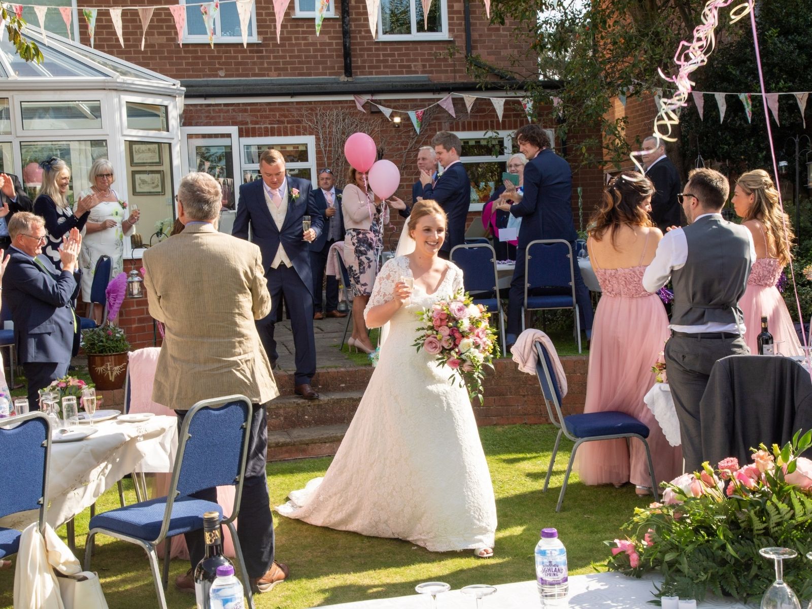 Rachel walking into her wedding reception in her parents' garden