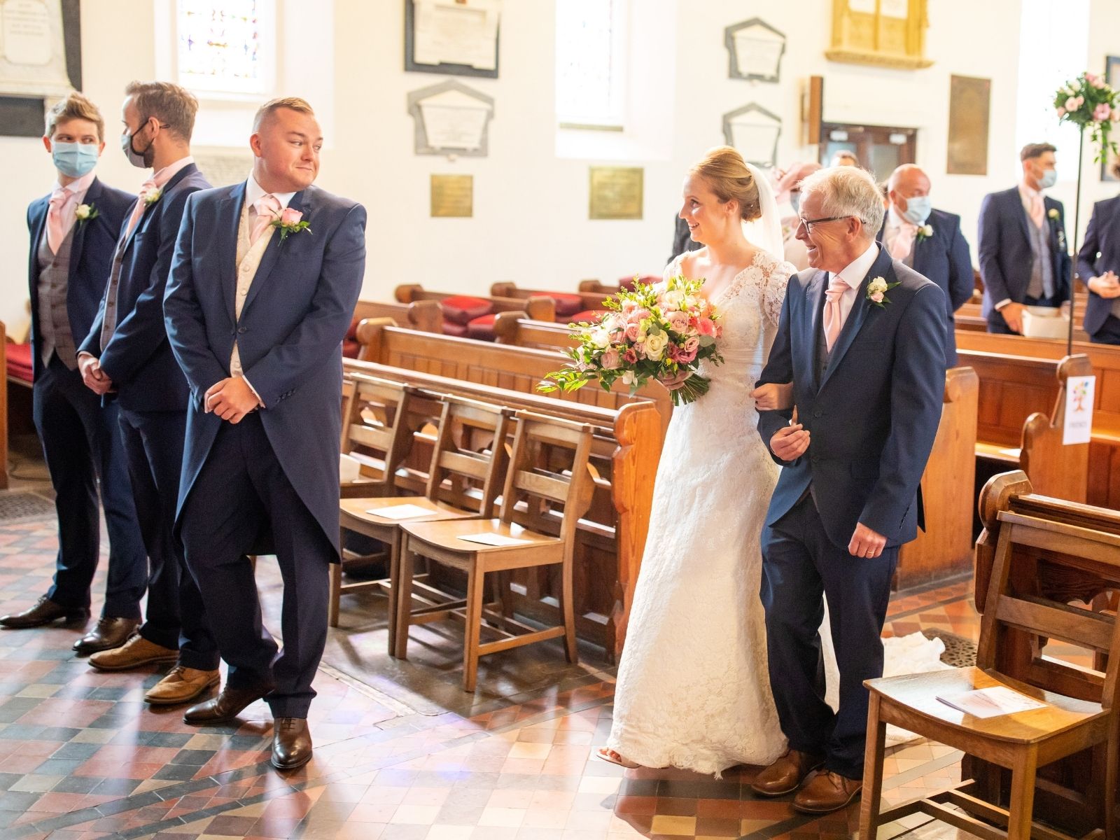 Rachel and Shaun at the alter in a bare church, for their socially-distanced lockdown wedding