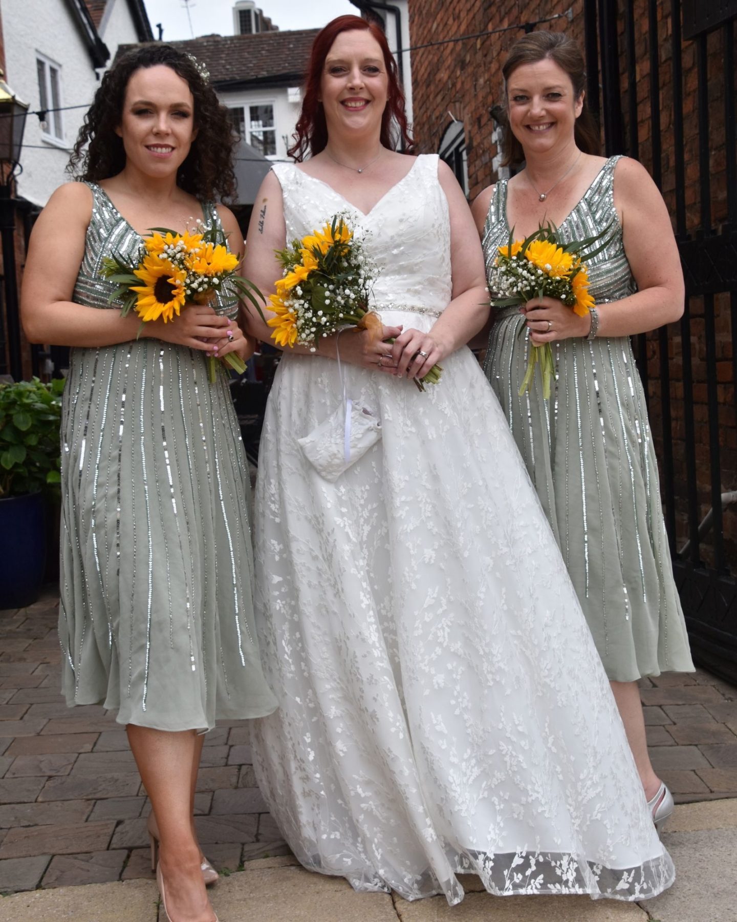 Alternative bride with her bridesmaids in green bridesmaid dresses